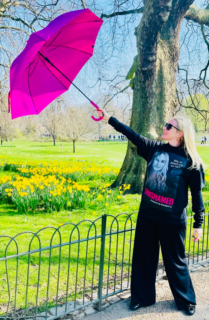 Elizabeth G. holding a pink umbrella